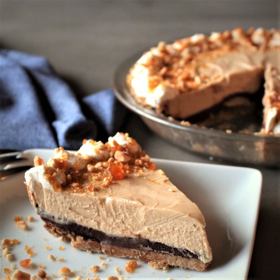 A slice of benut butter silk pie with candied peanut topping